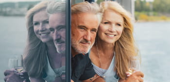 A couple looking out of their Spirit of the Rhine cabin window
